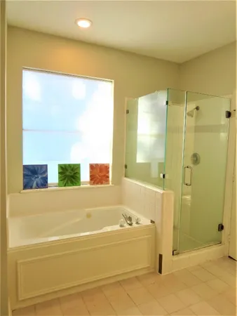 a bathroom with a bathtub and a shower