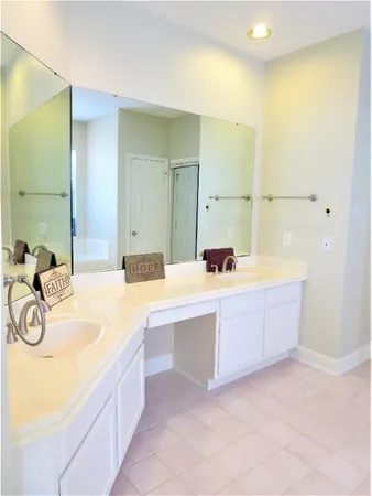 a bathroom with a sink a mirror and a bathtub