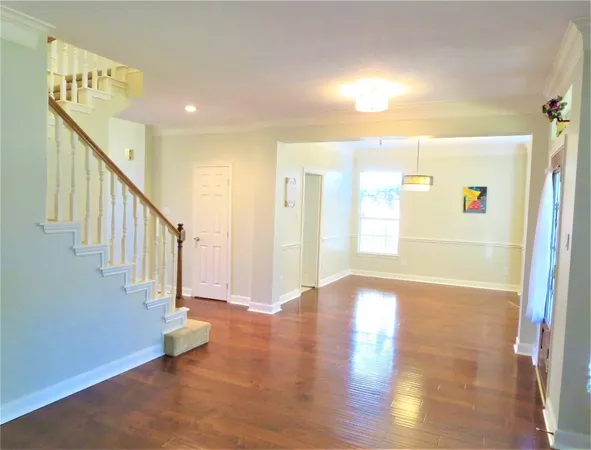 a view of an entryway with wooden floor