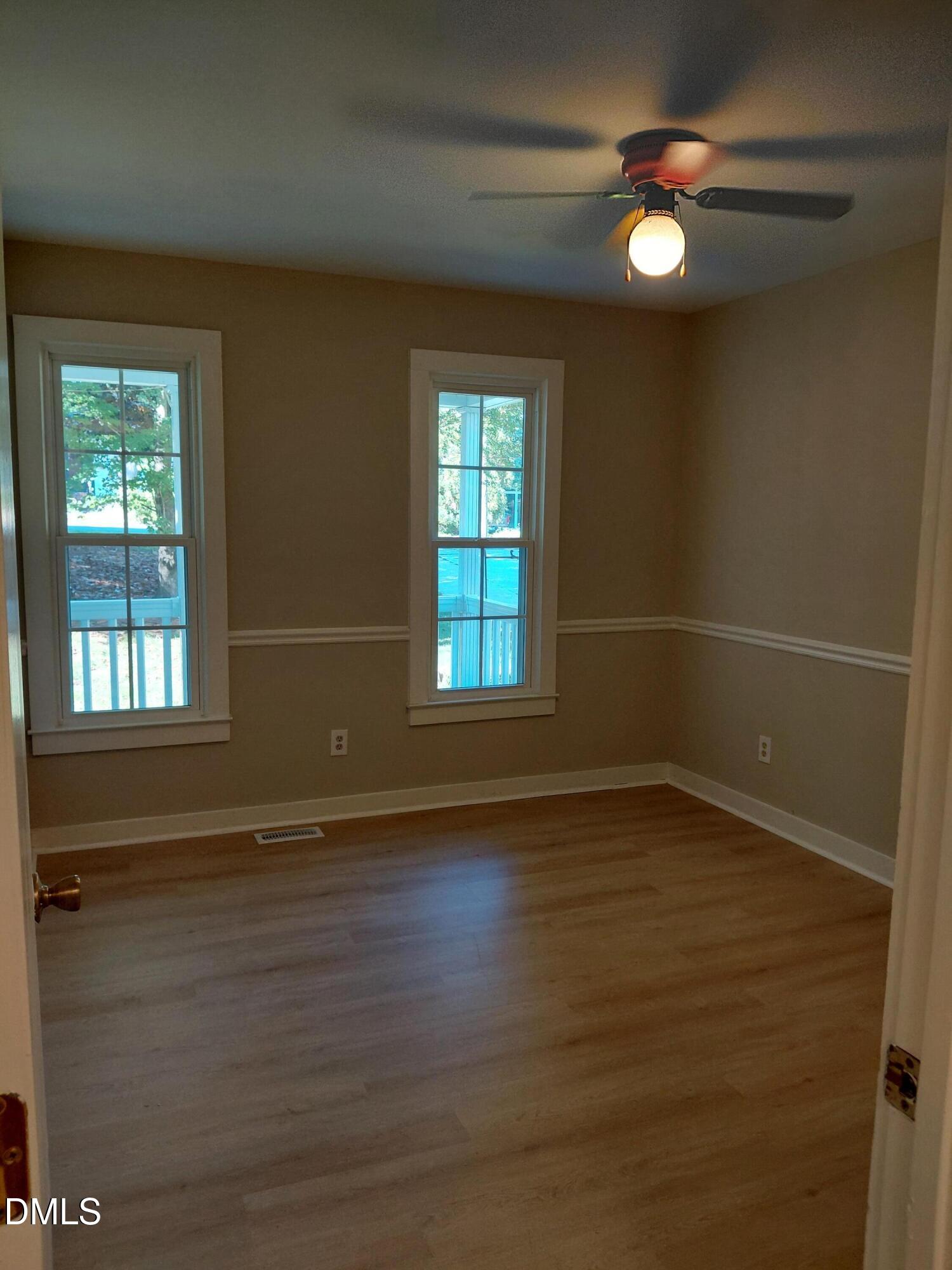 804 Olive Street Apex, NC 27502 - Photo 36 of 60 an empty room with wooden floor and windows