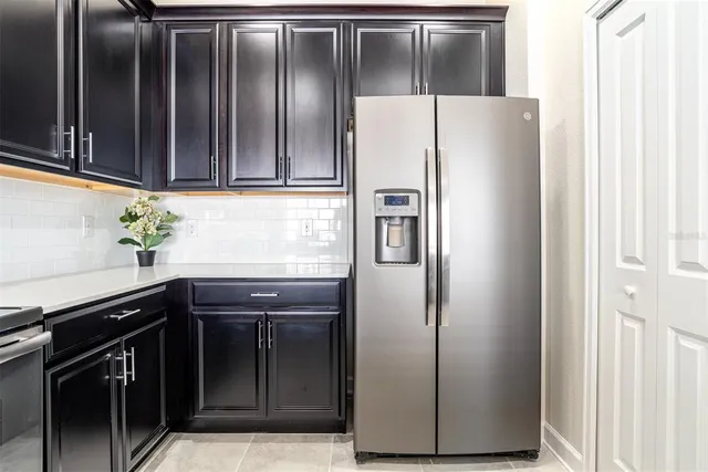 a kitchen with cabinets and stainless steel appliances