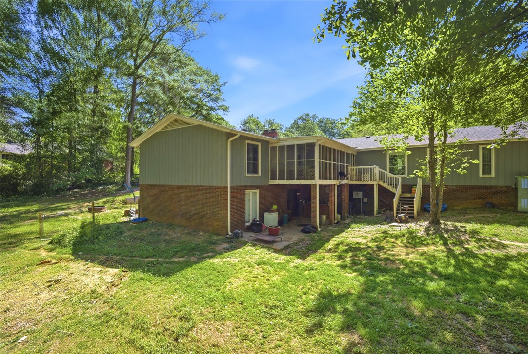 311 Cumberland Way Anderson, SC 29621 - Photo 41 of 44 Backyard with ample space for outdoor activities, featuring a spacious screened porch and convenient deck access.