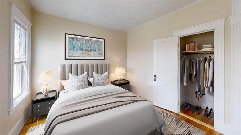 303 Tappan Street, Unit 3 Brookline, MA 02445 - Photo 7 of 10 a bedroom with a bed and a painting on the wall