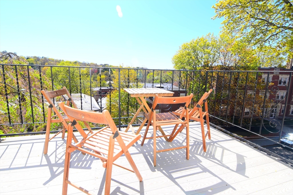 303 Tappan Street, Unit 3 Brookline, MA 02445 - Photo 9 of 10 a view of a swimming pool with outdoor seating and city view