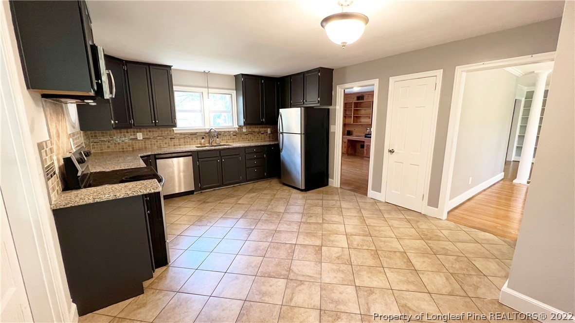516 Valley Road Fayetteville, NC 28305 - Photo 13 of 48 a kitchen with stainless steel appliances granite countertop a refrigerator and a sink
