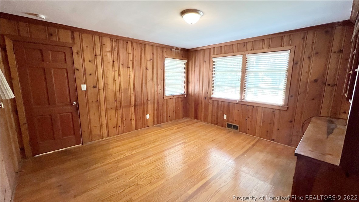 516 Valley Road Fayetteville, NC 28305 - Photo 25 of 48 a view of an empty room with wooden floor and a window