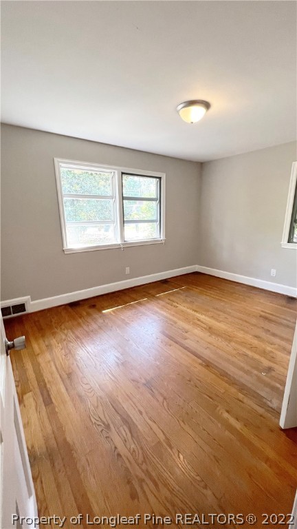516 Valley Road Fayetteville, NC 28305 - Photo 30 of 48 an empty room with wooden floor and windows