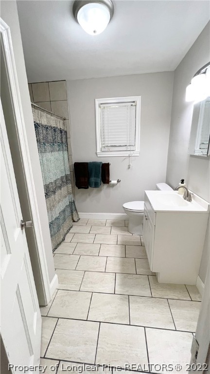 516 Valley Road Fayetteville, NC 28305 - Photo 32 of 48 a bathroom with a sink a toilet and mirror