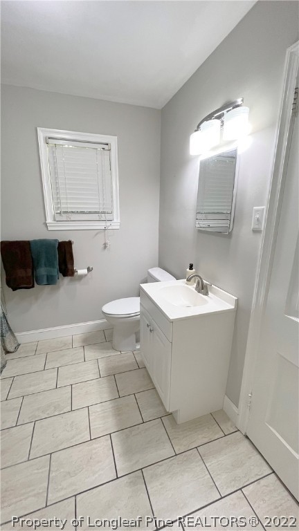 516 Valley Road Fayetteville, NC 28305 - Photo 33 of 48 a bathroom with a sink mirror and vanity