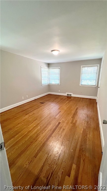 516 Valley Road Fayetteville, NC 28305 - Photo 36 of 48 an empty room with wooden floor and windows