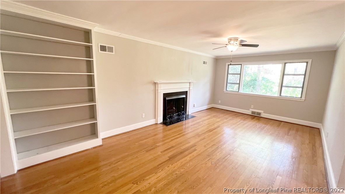 516 Valley Road Fayetteville, NC 28305 - Photo 6 of 48 a view of an empty room with a window and wooden floor