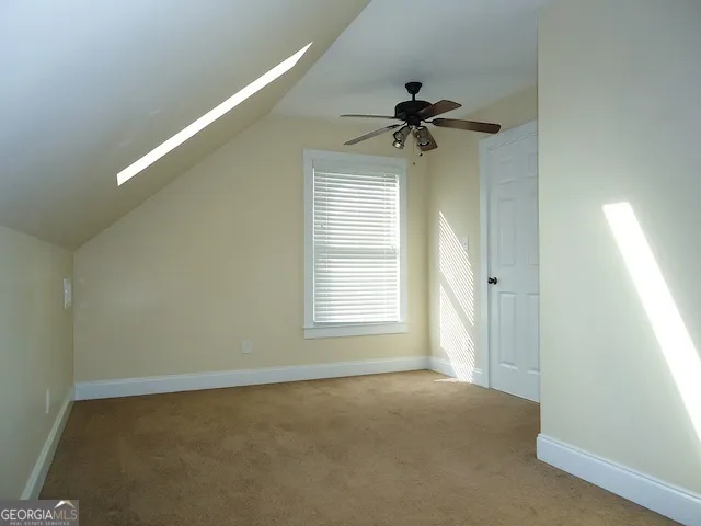 a view of a livingroom with a ceiling fan and window