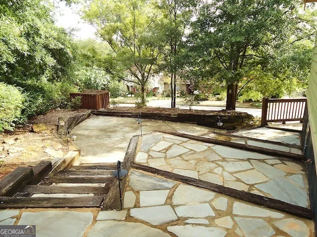 a view of backyard with swimming pool and seating space