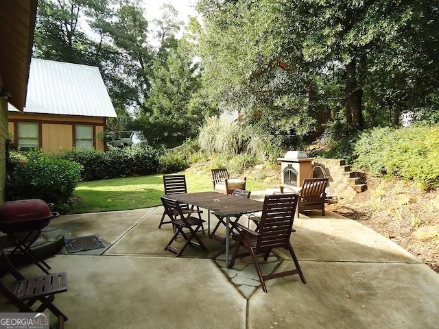 a view of a patio with table and chairs and potted plants