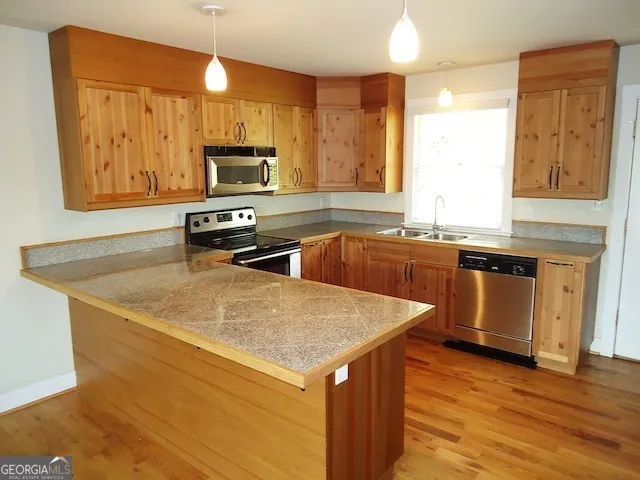 a kitchen with a sink a stove and a microwave