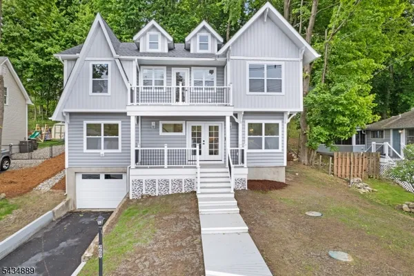 a front view of a house with a garden