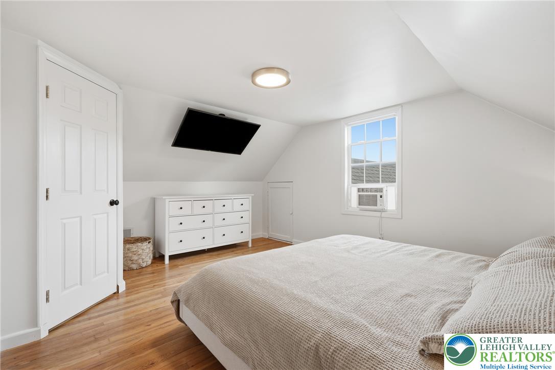 408 Maple Road Hellertown, PA 18055 - Photo 28 of 66 Slanted ceilings and rich hardwood flooring define this comfortable upper-level bedroom retreat.