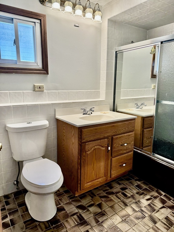 10 Clay Avenue Everett, MA 02149 - Photo 11 of 17 a bathroom with a toilet sink vanity and mirror