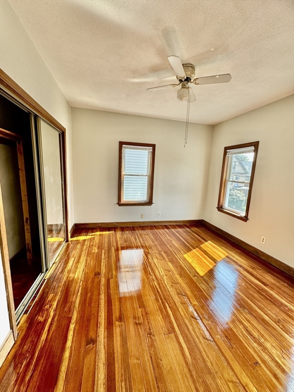 10 Clay Avenue Everett, MA 02149 - Photo 14 of 17 a view of a livingroom with wooden floor and a ceiling fan