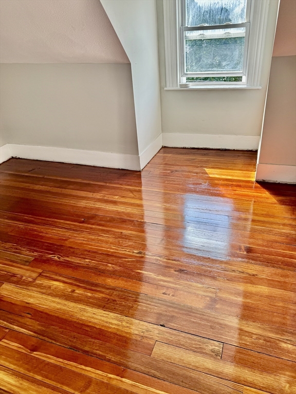 10 Clay Avenue Everett, MA 02149 - Photo 16 of 17 a view of an empty room with wooden floor and a window