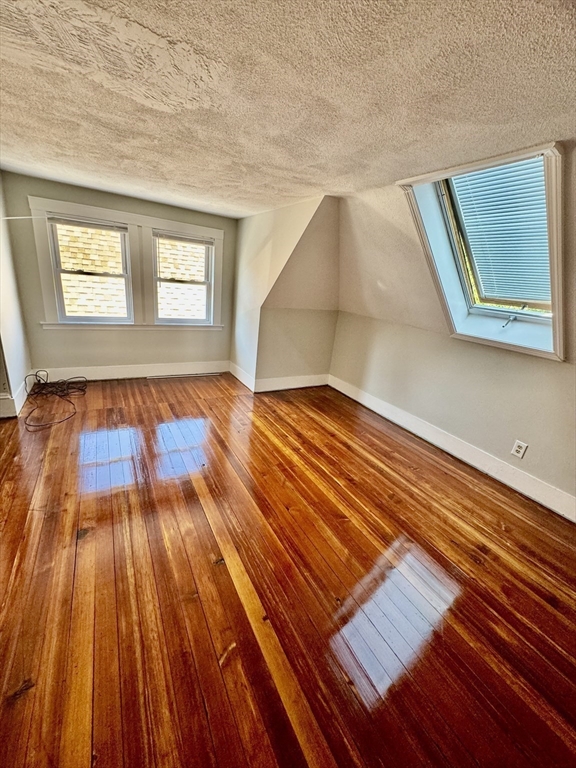 10 Clay Avenue Everett, MA 02149 - Photo 17 of 17 a view of an empty room with wooden floor and a window