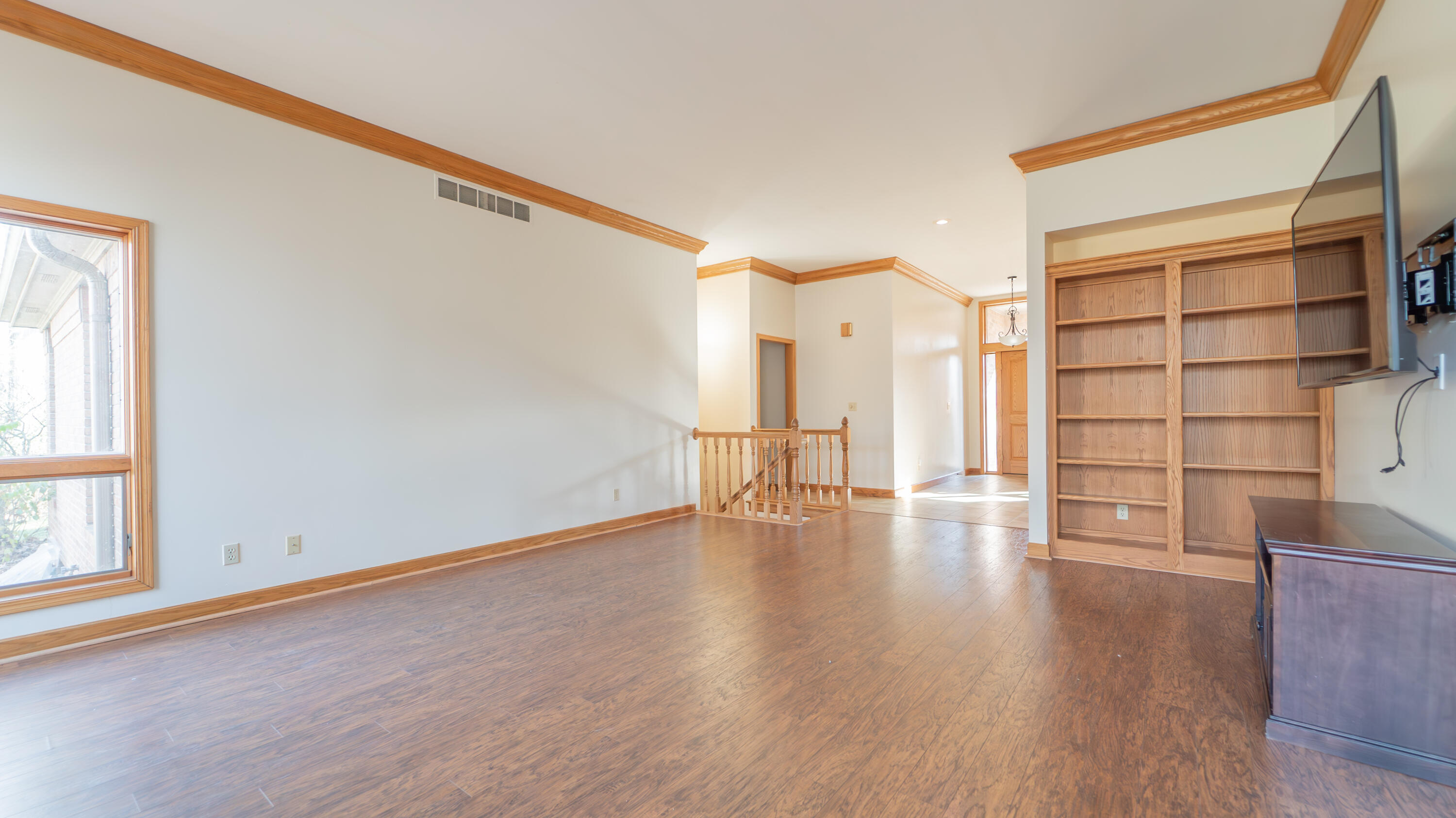 6614 Ridgeview Drive Demotte, IN 46310 - Photo 11 of 50 a view of an empty room with wooden floor and entryway