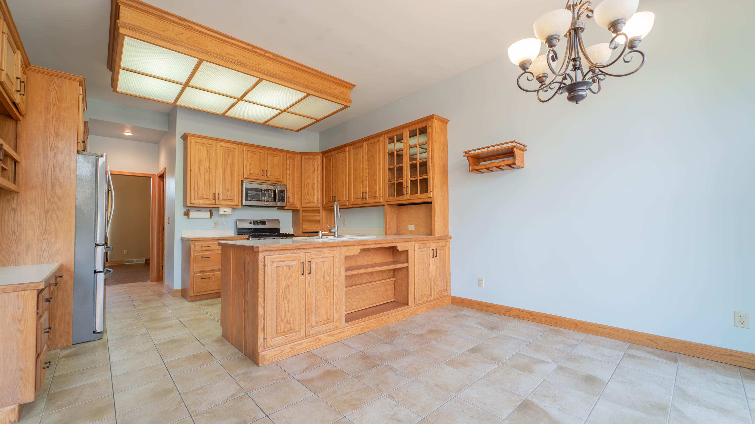 6614 Ridgeview Drive Demotte, IN 46310 - Photo 14 of 50 a kitchen with stainless steel appliances a refrigerator and cabinets
