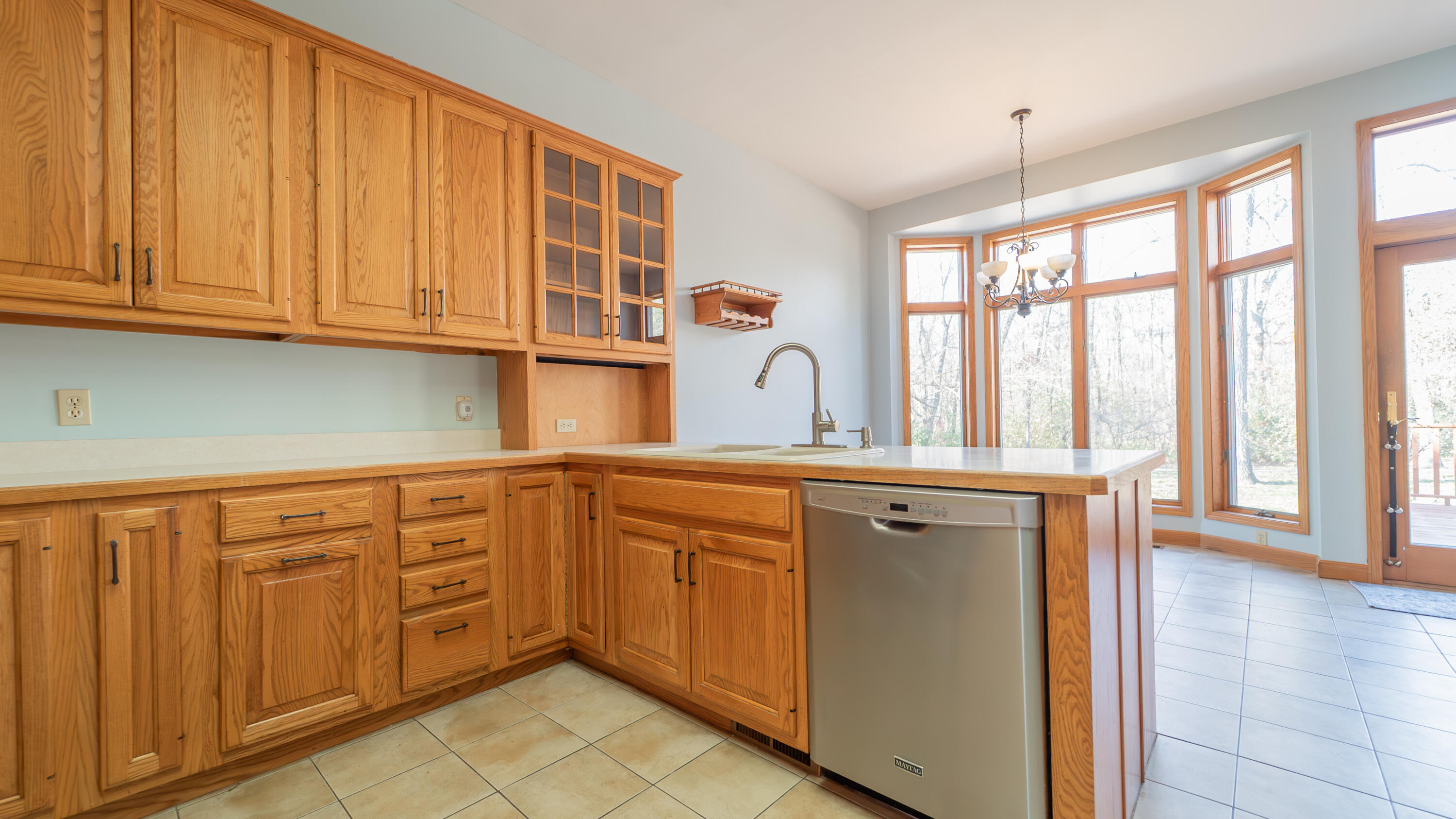 6614 Ridgeview Drive Demotte, IN 46310 - Photo 17 of 50 a kitchen with stainless steel appliances granite countertop a refrigerator a sink dishwasher and wooden cabinets with wooden floor