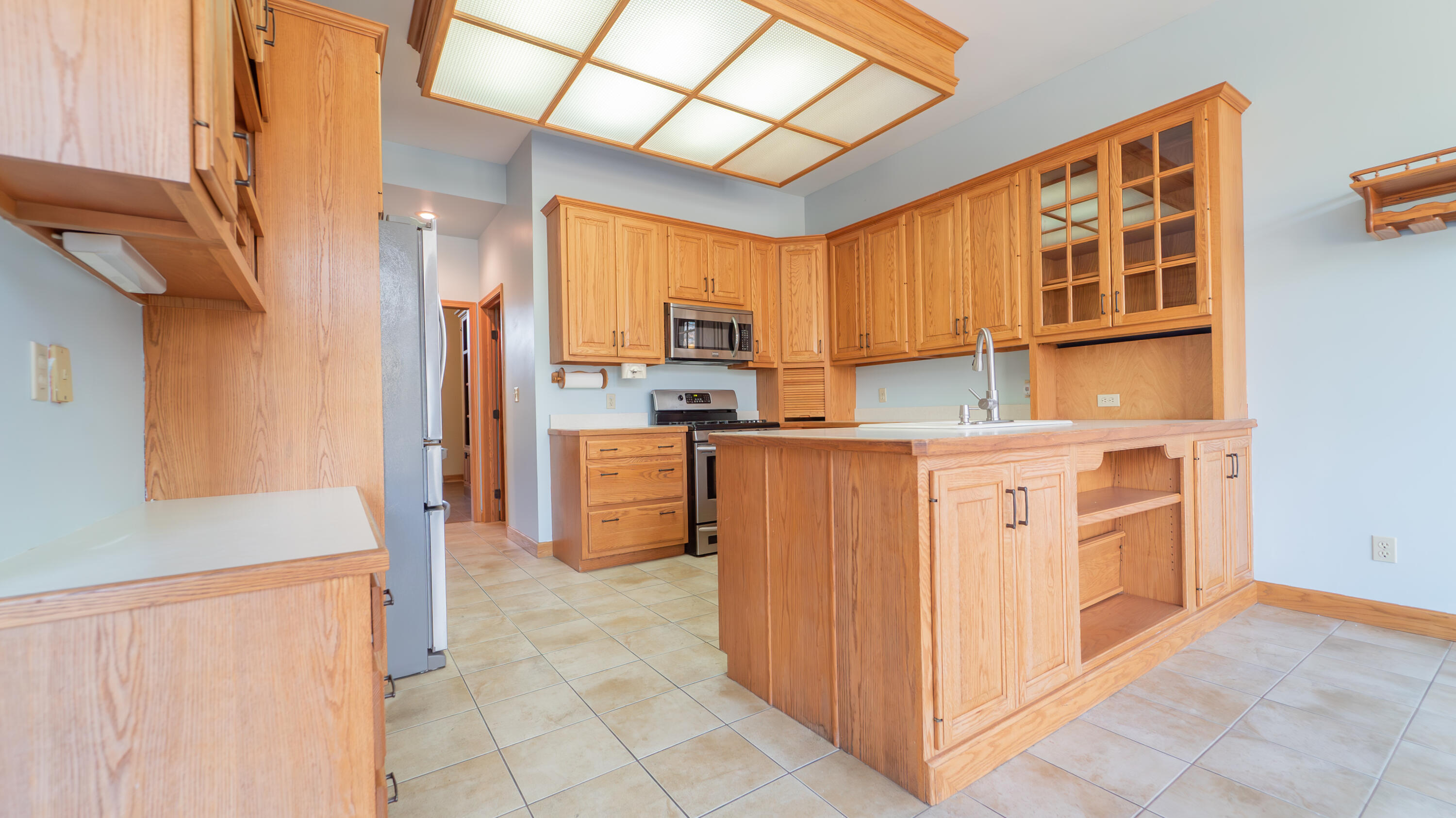 6614 Ridgeview Drive Demotte, IN 46310 - Photo 19 of 50 a kitchen with stainless steel appliances a refrigerator and a stove