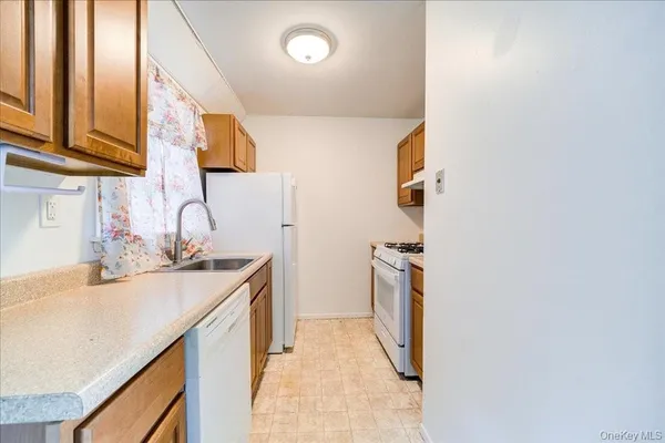 a kitchen with a sink and a refrigerator