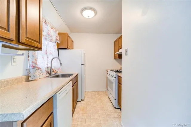 a kitchen with a sink and a refrigerator