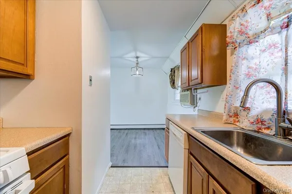 a kitchen with a sink a stove and cabinets