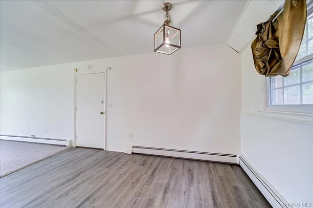 a view of small space with wooden floor and windows