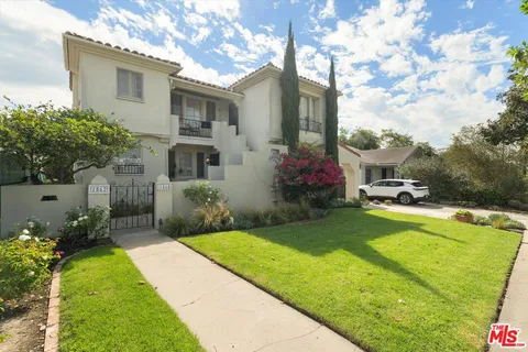 a house view with swimming pool and garden space