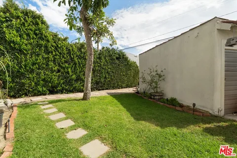 a view of backyard with barbeque grill and outdoor seating