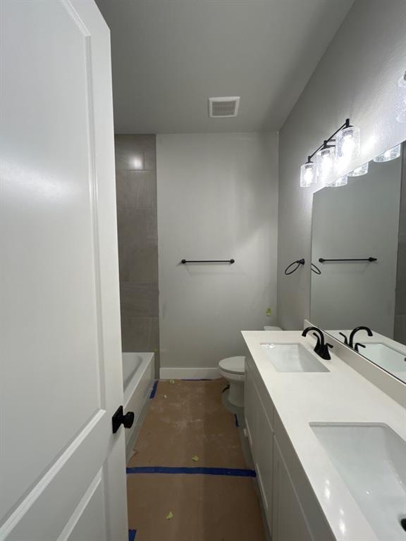 803 Vly Rdg Road Van Alstyne, TX 75495 - Photo 11 of 15 a bathroom with a sink a toilet and shower