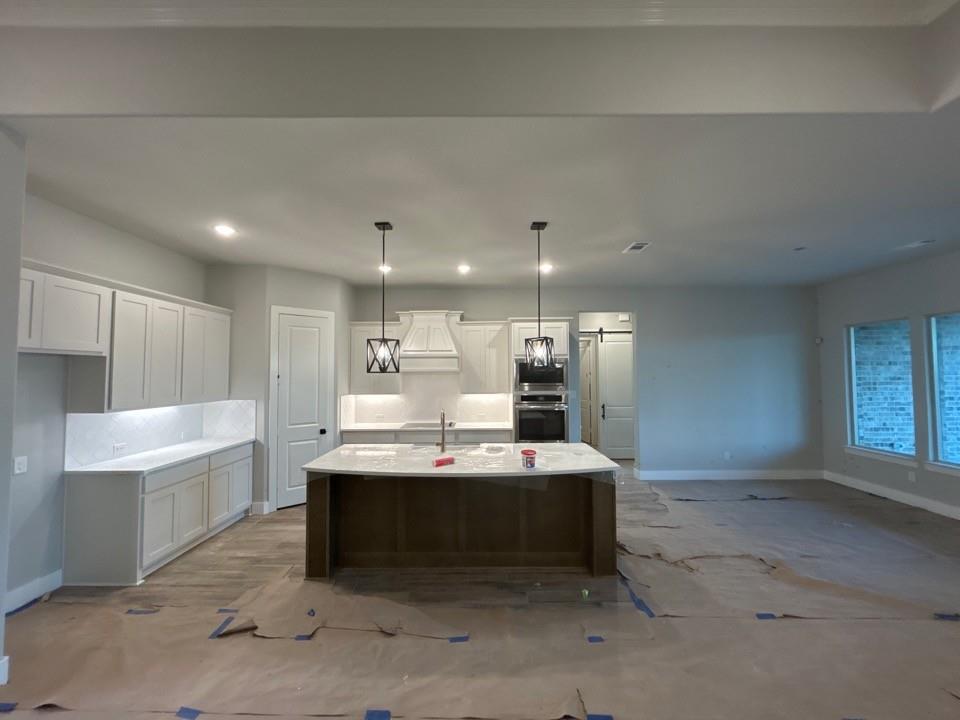 803 Vly Rdg Road Van Alstyne, TX 75495 - Photo 7 of 15 a large white kitchen with a sink stainless steel appliances and cabinets