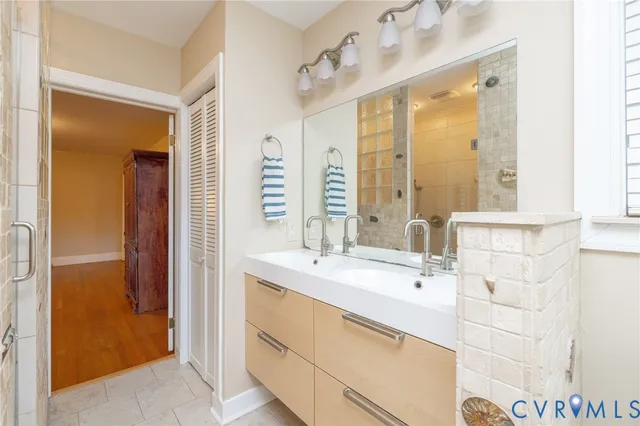 a view of a white house next to a road and yard