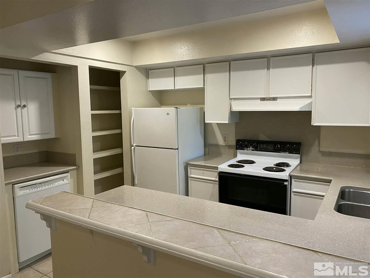3350 Pierremont Road Reno, NV 89503 - Photo 4 of 15 a kitchen with cabinets and stainless steel appliances