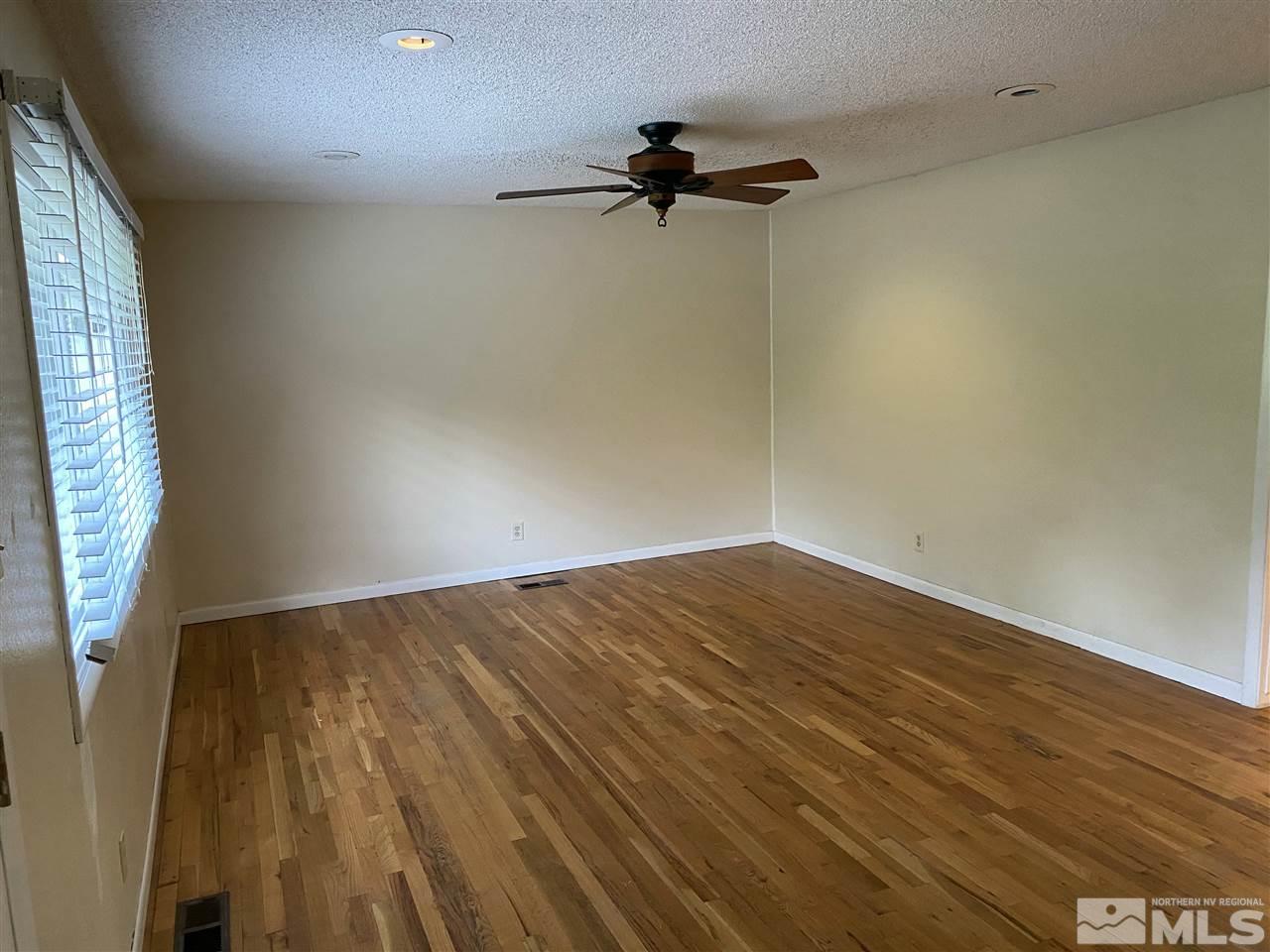 3350 Pierremont Road Reno, NV 89503 - Photo 5 of 15 wooden floor in an empty room with a window