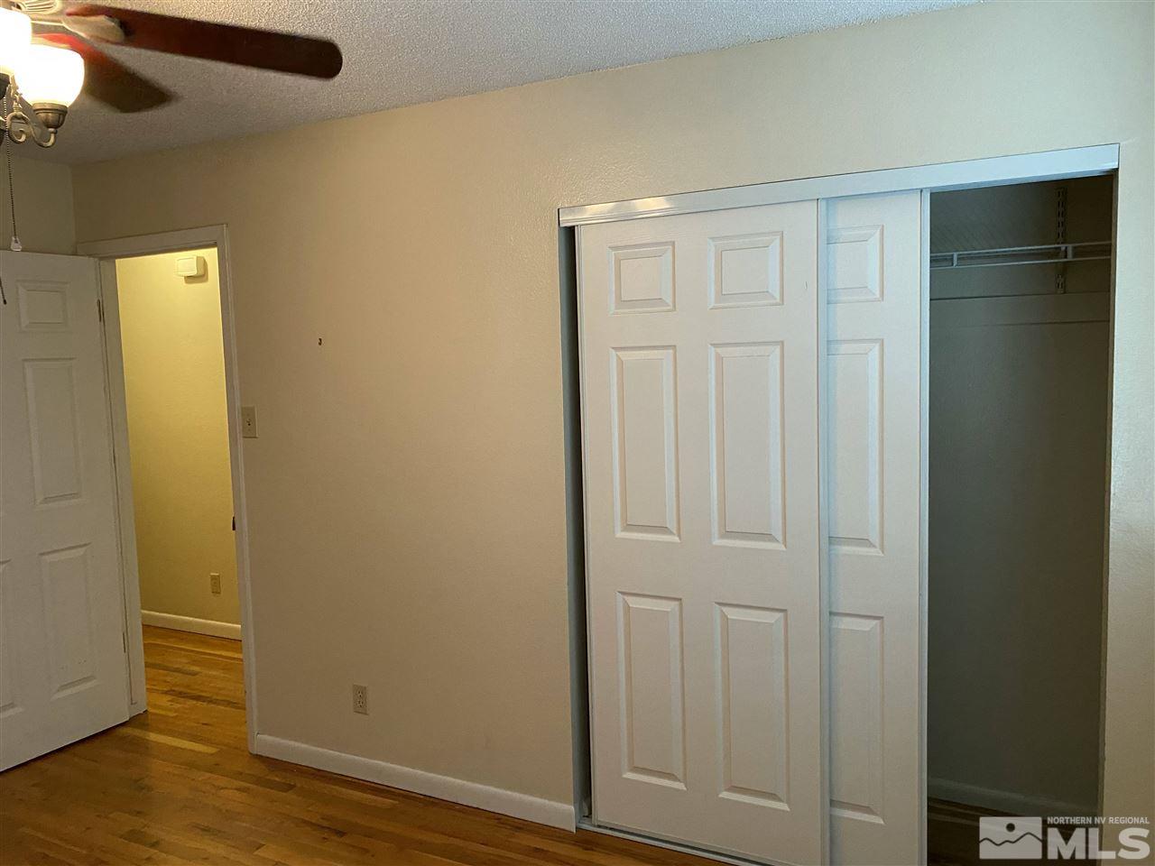 3350 Pierremont Road Reno, NV 89503 - Photo 8 of 15 an empty room with wooden floor and closet