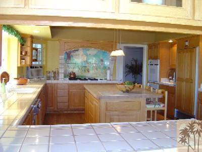 35680 Butterfly Peak Road Mountain Center, CA 92561 - Photo 8 of 19 a kitchen with kitchen island granite countertop a sink and a stove