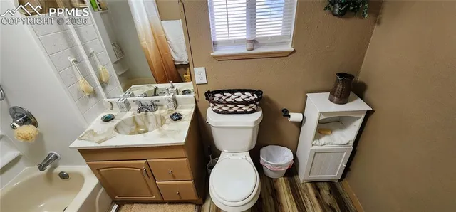 a bathroom with a sink toilet and mirror