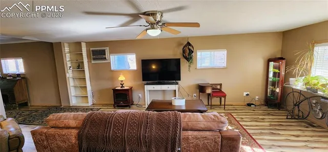 a living room with fireplace furniture and a flat screen tv