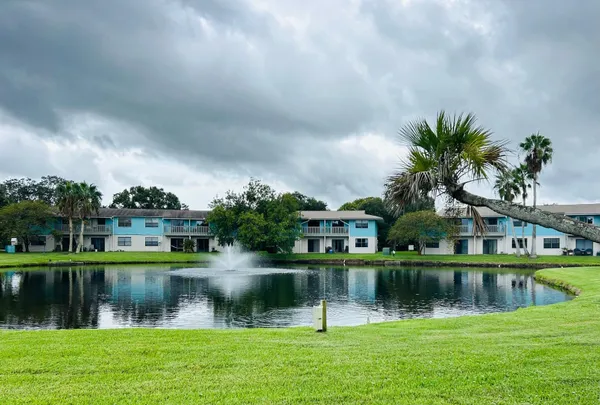 a view of lake with a house in the background