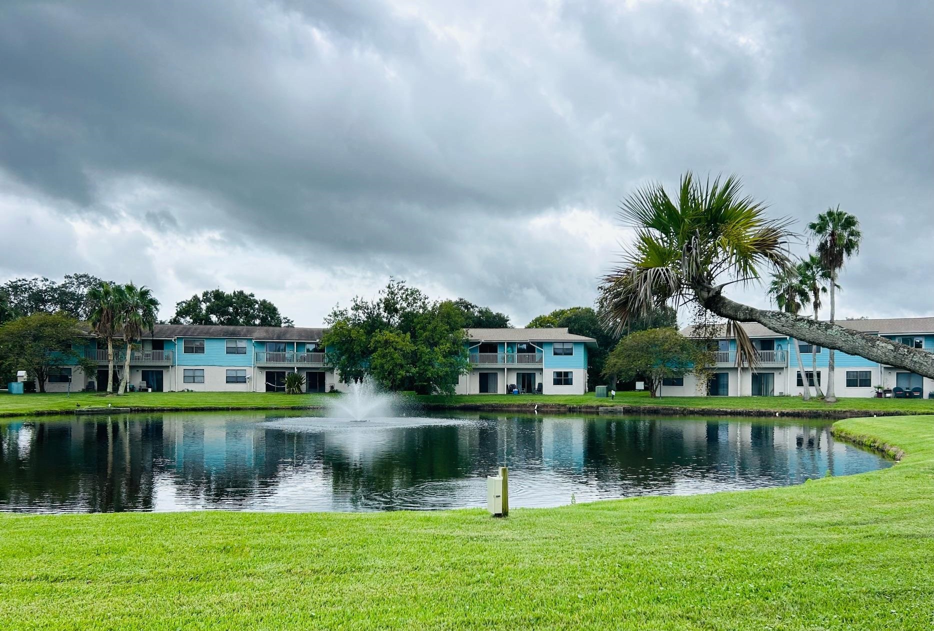 a view of lake with a house in the background
