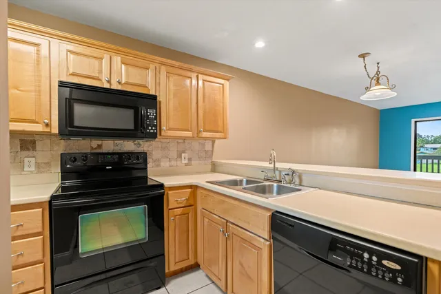 a kitchen with a sink stove and microwave
