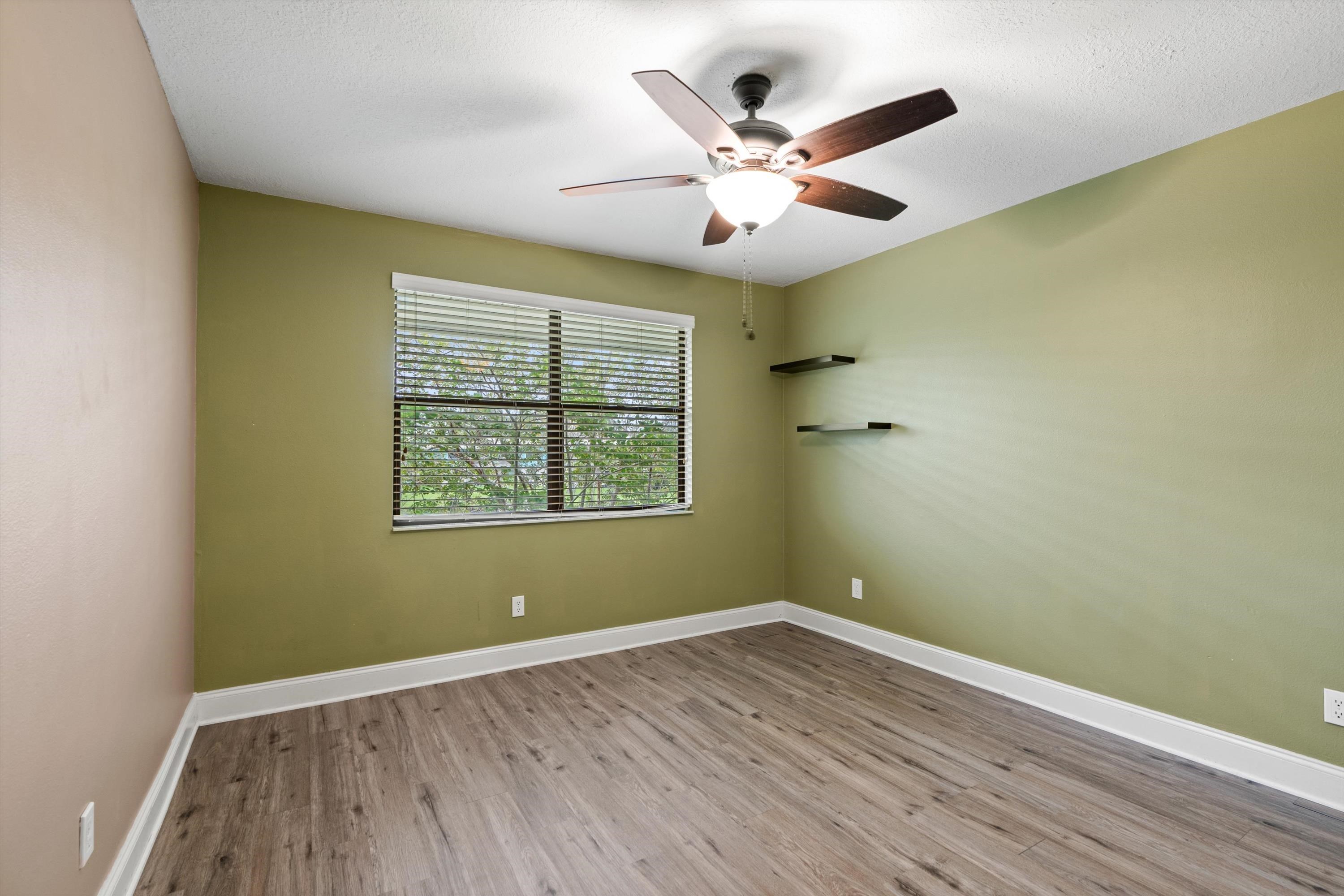 650 West Pope Road, Unit 208 St. Augustine, FL 32080 - Photo 16 of 35 wooden floor in an empty room with a window