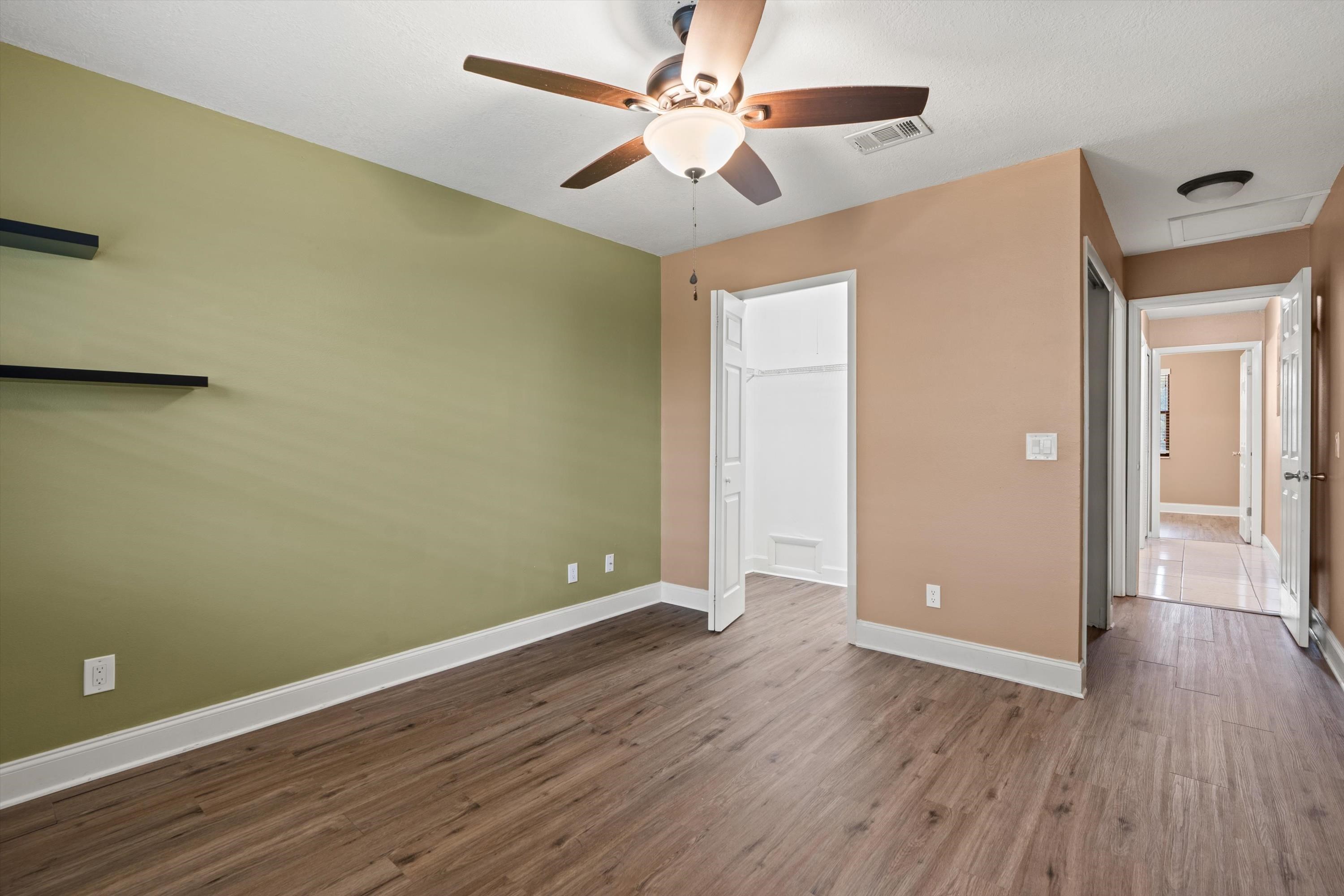 650 West Pope Road, Unit 208 St. Augustine, FL 32080 - Photo 17 of 35 an empty room with wooden floor and a ceiling fan