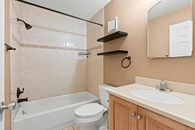 a bathroom with a sink toilet vanity and shower